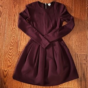 Cute maroon/plum long sleeve minidress with full skirt and pockets!